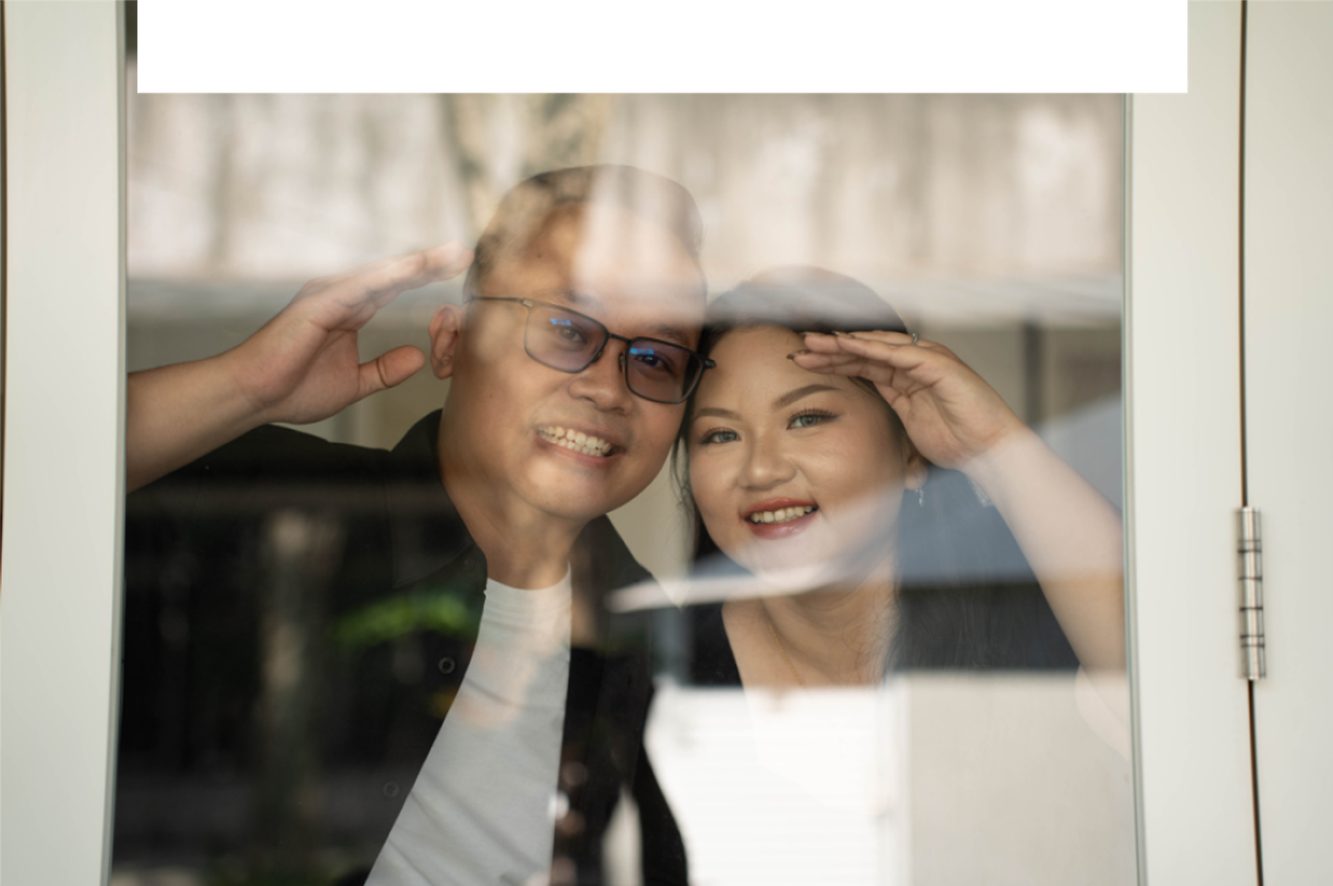 Billy and Clarrisa behind a window
